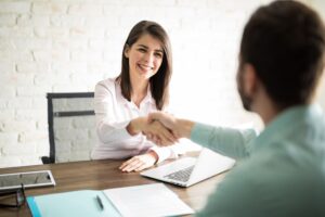 Point of view of a young man giving a woman a handshake after sealing a deal with her